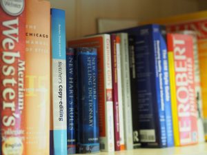 Bookshelf with dictionaries | Localisation | German translation services